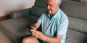 A senior person using voice-activated technology in a modern, accessible home environment.