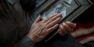 A person holding an old family photograph.