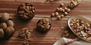 A spread of selenium-rich foods like Brazil nuts and fish on a wooden table.