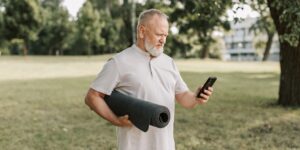 An older adult preparing for seated mobility exercises in a comfortable living room.