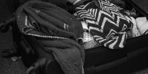 A minimalist, organized suitcase packed for a cultural museum trip.