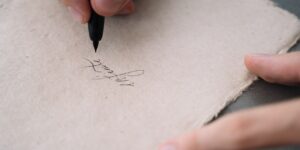 Close-up of a person practicing elegant calligraphy on paper