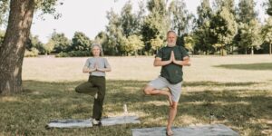 An active older couple walking in a park, representing healthy aging and mobility.