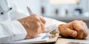 A healthy senior adult planning their health schedule in a bright, modern setting.