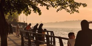 A scenic and accessible riverfront hotel promenade at sunset.