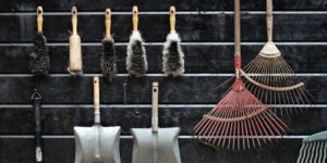 A well-organized community tool lending library shed filled with garden equipment.
