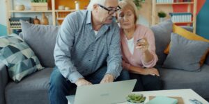A senior and a family member discussing digital estate planning on a tablet.