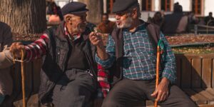 Older adults interacting and sharing tools in a community garden.