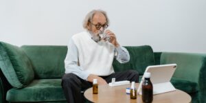 A senior person using a tablet to manage health records in a bright, modern room.